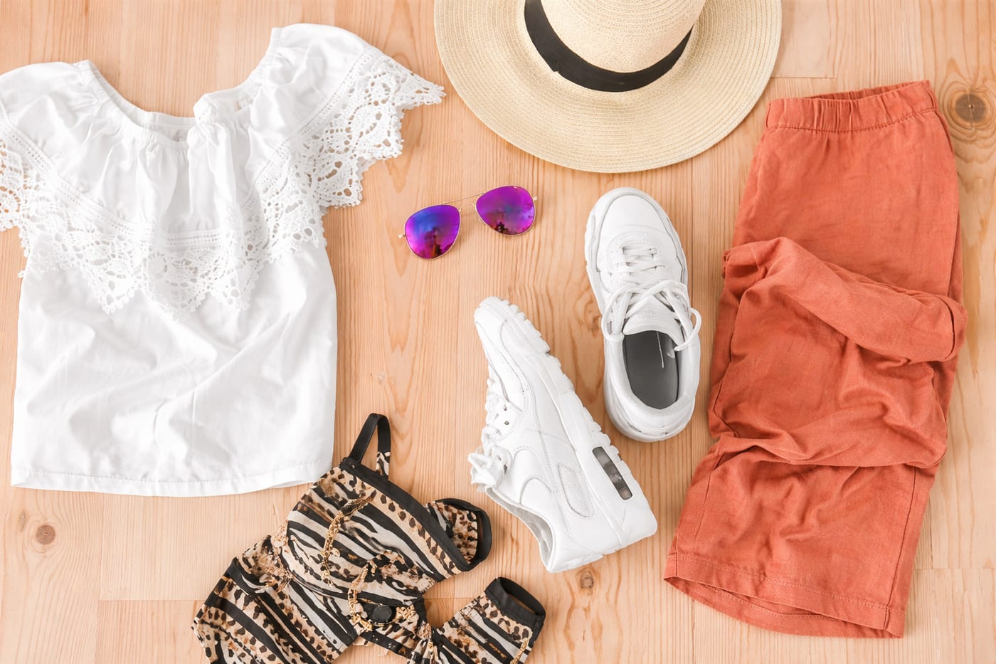 Refined travel wardrobe on a bed